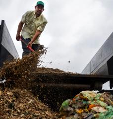Leo Brito, Founder of Zero Waste Houston, dumps wood chips during a composting class.